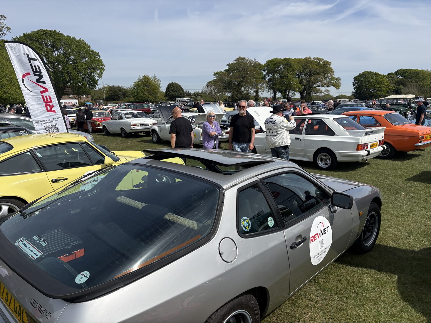 Enthusiasts and their cars gathered at a club meet